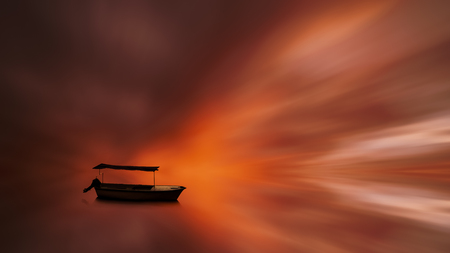 fishing boat with reflection on the water with a blurred clouds sky full of fantastic colorsの写真素材