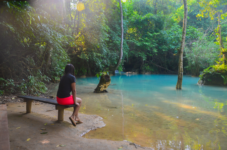 Rear view of asian girl looking at the colorful waters in Laosの写真素材