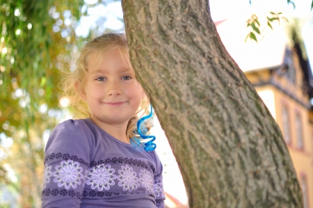 Litle girl playing in autumn park, Happy child の写真素材