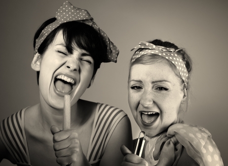 Two women singing together  Karaoke, retro style の写真素材