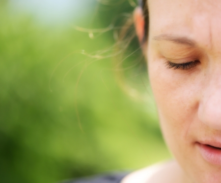 Half face of beautiful natural woman on background of green trees  Very high resolution の写真素材