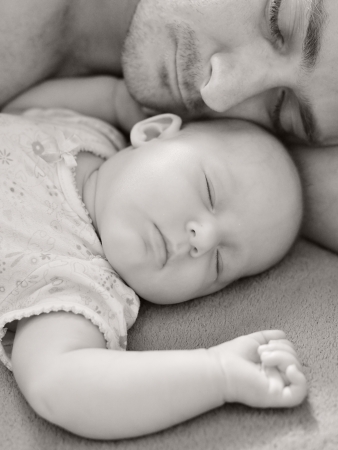Father sleep with his baby の写真素材
