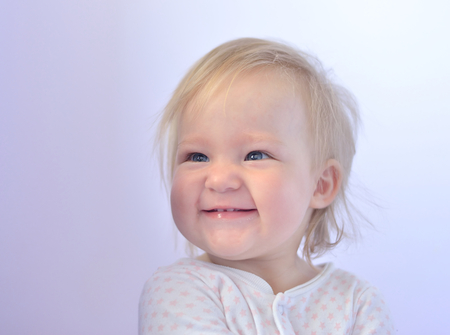Cute baby with blue eyes in bright colors の写真素材