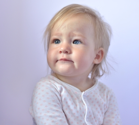 Cute baby with blue eyes in bright colors の写真素材