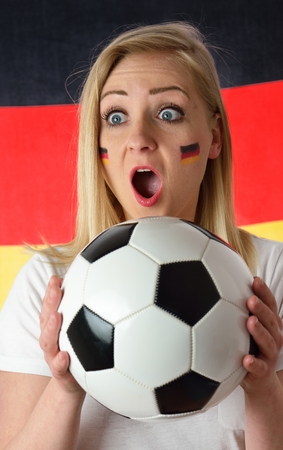 German soccer fan cheers football team in the national colors.の写真素材