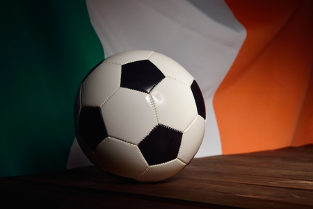 Flag of Ireland with football on wooden boards as the background.の写真素材