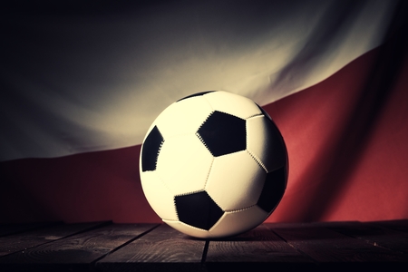 Flag of Poland with football on wooden boards as the background. Vintage Style.の写真素材