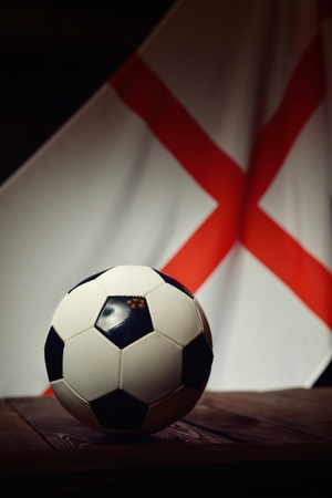 Flag of England with football on wooden boards as the background.の写真素材