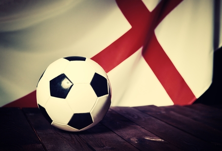 Flag of England with football on wooden boards as the background. Vintage Style.の写真素材