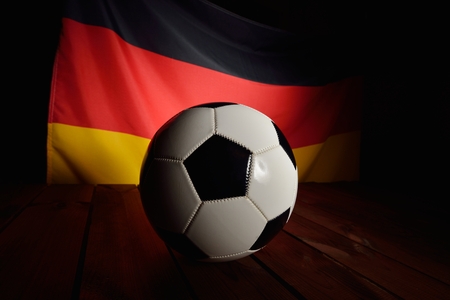 Flag of Germany with football on wooden boards as the background.の写真素材