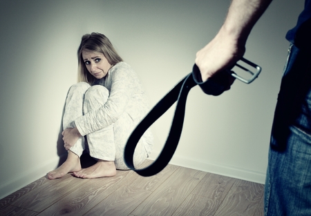 Woman afraid of her husband, who wants to beat her. Domestic violence.の写真素材