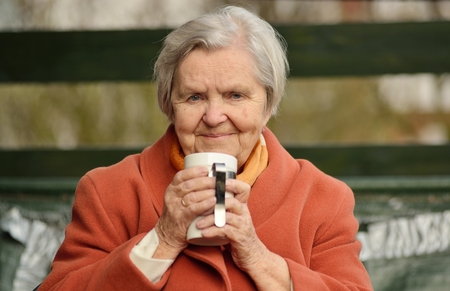 Senior happy woman smiling in garden.