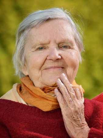 Senior happy woman smiling in garden.の写真素材