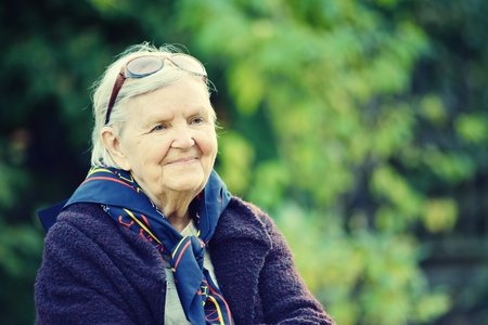 Senior happy woman smiling in garden.の写真素材