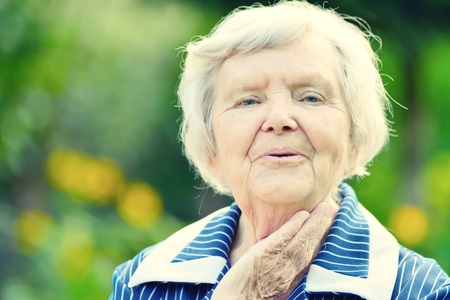 Senior happy woman smiling in garden.の写真素材