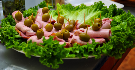 snacks on a plate decorated with greeneryの写真素材