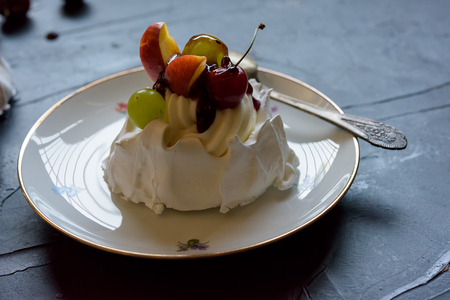 Pavlova dessert with fruit on small plateの写真素材