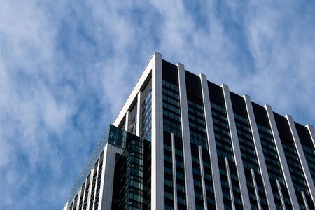 Top corner of office building a blue sky and cloud somewhere in Ueno, Japan gives a modern feel....