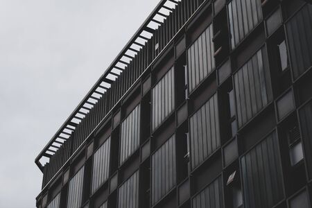 Abstract black office building and background gray light sky feel modern. Photo taken somewhere in Tokyo, Japan.の写真素材
