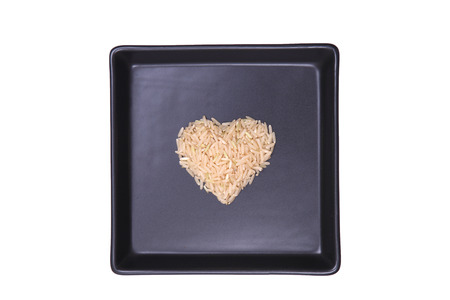 rice heart shape as black plateの写真素材