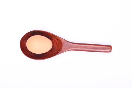 egg on wood spoonの写真素材