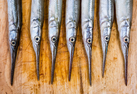 Fresh fish on wooden kitchen boardの写真素材