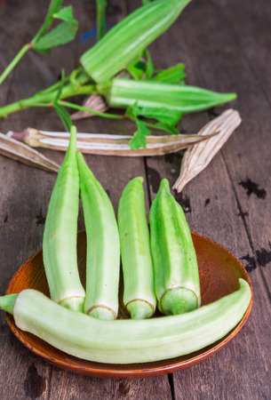 Lady Fingers or Okra over wooden backgroundの写真素材