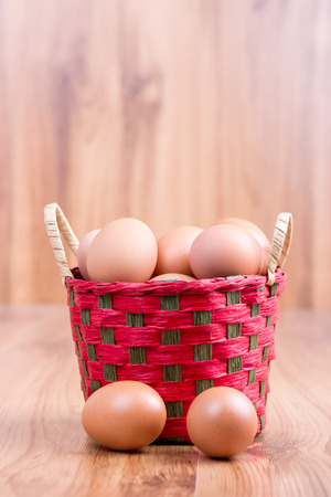 egg in a basket  on wodden tableの写真素材