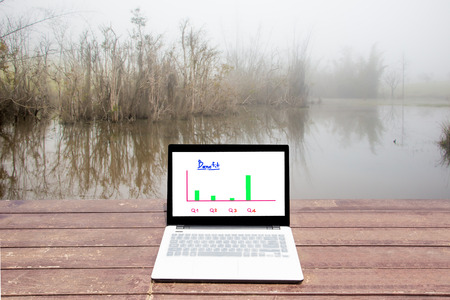 laptop on wooden table with natural background