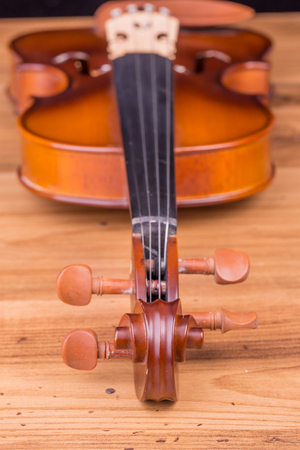 Vintage violin on wooden backgroundの写真素材