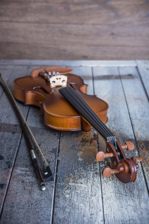 Vintage violin on wooden backgroundの写真素材