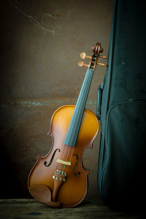 Vintage violin with old steel backgroundの写真素材