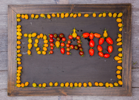 frame of red and yellow tomatoesの写真素材