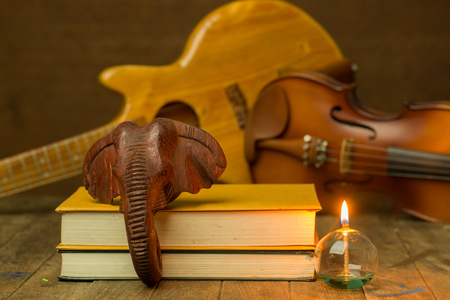 Acoustic guitar,violin,lantern  on floor still life styleの写真素材
