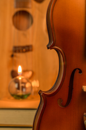 Acoustic guitar,violin,lantern  on floor still life styleの写真素材
