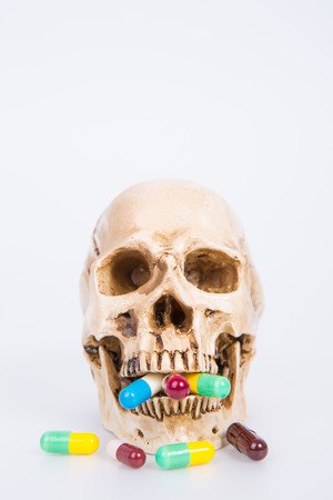 human skull with medical drugsの写真素材