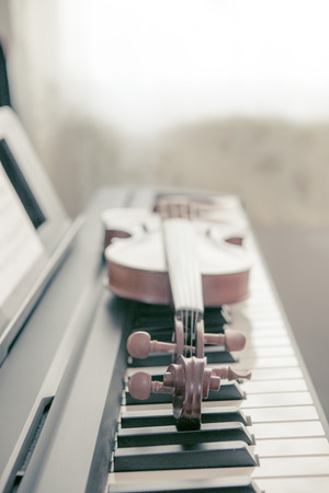 The violin lies on keys digital pianoの写真素材
