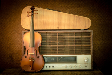 violin and old radio in vintage style on steel backgroundの写真素材