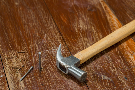 Hammer and nails on woodの写真素材