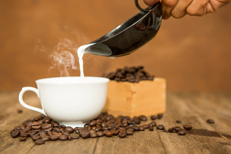 Coffee cup and beans on wooden,top viewの写真素材
