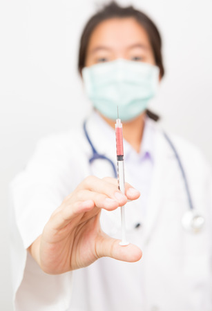 doctor woman with syringe isolated on whiteの写真素材
