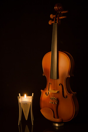 classical violins with  candle on black backgroundの写真素材