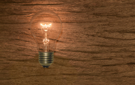 electric bulb on wooden backgroundの写真素材