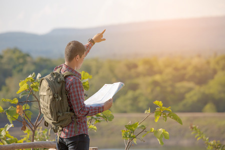 Man tourist in mountain read the map. Tourism conceptの写真素材