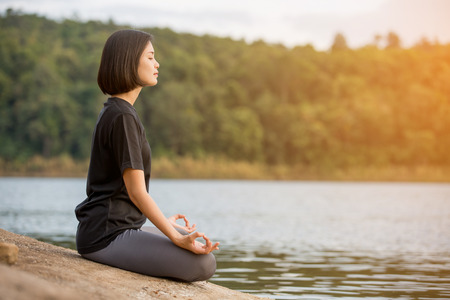 asian woman Yoga relax in nature to relax outdoorの写真素材