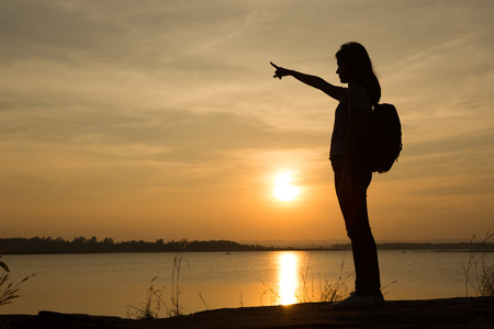 Young woman relaxing in summer sunset sky outdoorの写真素材
