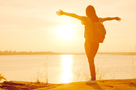 Young woman relaxing in summer sunset sky outdoorの写真素材