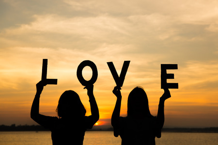 Silhouette love in hand. Background sunriseの写真素材