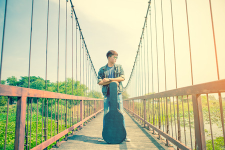 young man guitar player with cigareteの写真素材