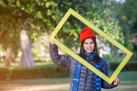 Portrait of Young Woman holding framee in the garden